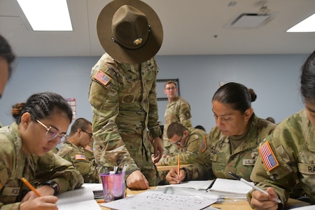 U.S. Army Soldier works with students attending the academic portion of the Future Soldier Preparatory Course