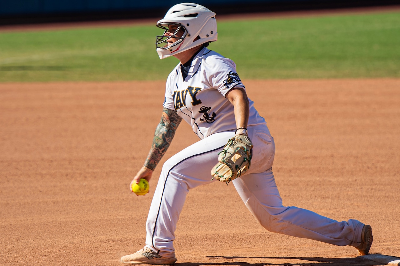A softball player prepares to throw a pitch.