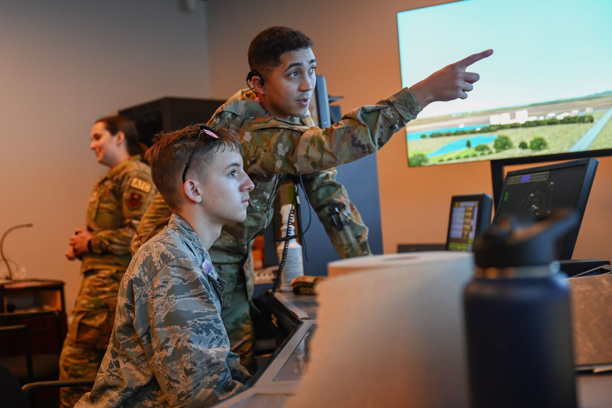 U.S. Air Force Airman 1st Class Jordon Riggins, right, 97th Operation Support Squadron air traffic control (ATC) apprentice, assists Grant Gagna, left, Altus Chapter Civil Air Patrol cadet, in an ATC simulator. This was a rare opportunity for the cadets as this simulator is utilized by ATC apprentices for their upgrade training. (U.S. Air Force photo by Airman 1st Class Jonah Bliss)