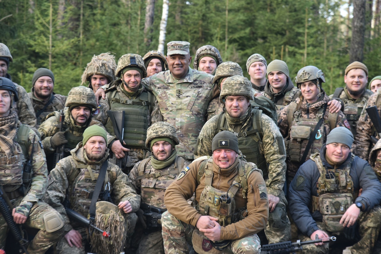 A U.S. service member poses with Ukrainian soldiers during a training exercise in Germany.