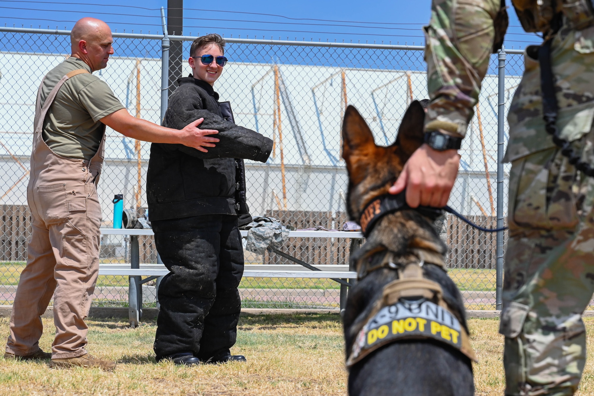 Grant Gagna, Altus Chapter Civil Air Patrol (CAP) cadet, prepares to be bitten by Griff, 97th Security Forces Squadron military working dog, at Altus Air Force Base, Oklahoma, Aug. 12, 2024. The CAP cadets got to experience the capabilities of military working dogs and the expertise of the handlers. (U.S. Air Force photo by Airman 1st Class Jonah Bliss)