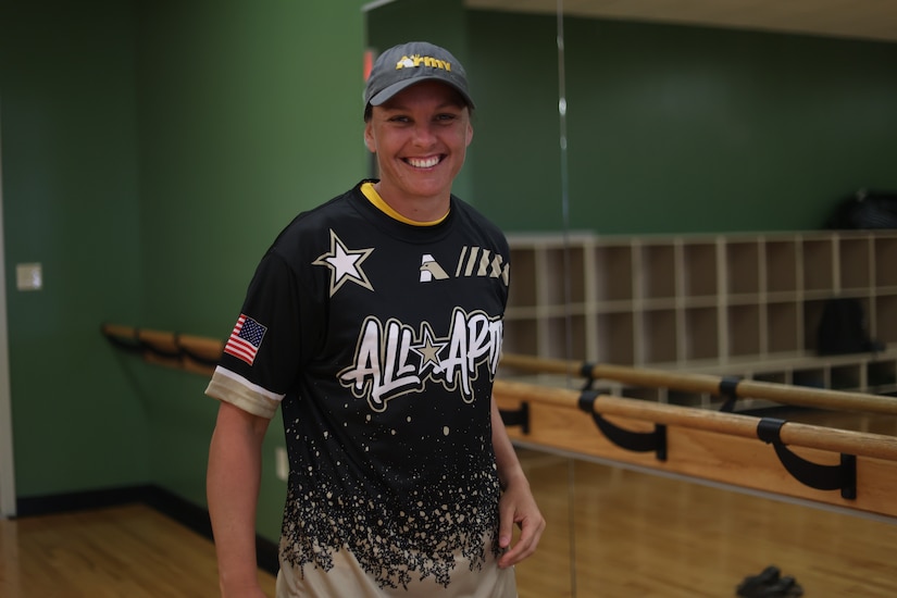 A woman wears a shirt that reads All-Army.