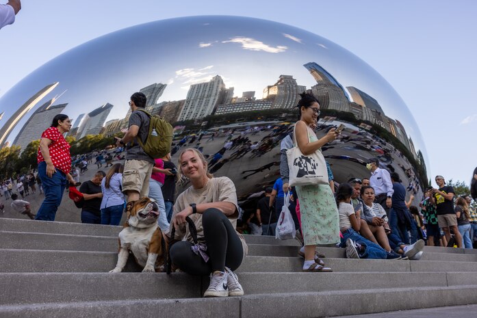U.S. Marine Corps Cpl. Sarah Grawcock, a combat photographer and mascot handler with Headquarters and Service Battalion, and Lance Cpl. Bruno, the Marine Corps Recruit Depot San Diego and Western Recruiting Region mascot, visit Cloud Gate, Chicago,  Aug. 10, 2024. Bruno attended the Chicago Air and Water Show  in  support of community relations and recruiting efforts. The Chicago Air and Water Show presented by the City of Chicago is the largest free show of its kind in the United States. (U.S. Marine Corps photo by Cpl. Alexander O. Devereux)