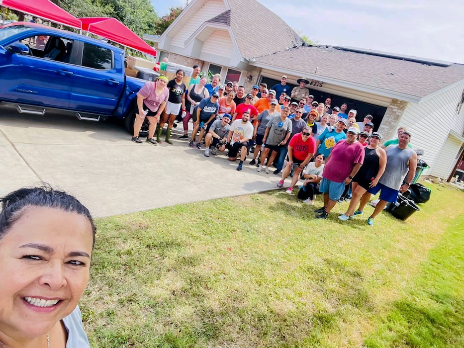 433rd Airlift Wing Reserve Citizen Airmen, family members, and friends pose for a photo with Master Sgt. Jesse Gonzalez July 7, 2024, outside his San Antonio, Texas home.