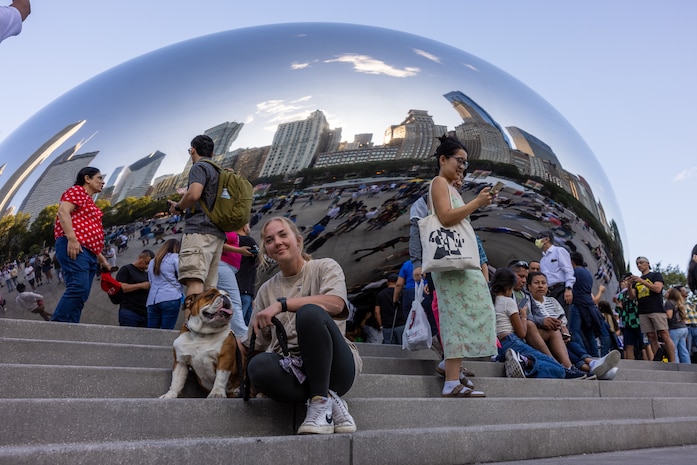 U.S. Marine Corps Cpl. Sarah Grawcock, a combat photographer and mascot handler with Headquarters and Service Battalion, and Lance Cpl. Bruno, the Marine Corps Recruit Depot San Diego and Western Recruiting Region mascot, visit Cloud Gate, Chicago,  Aug. 10, 2024. Bruno attended the Chicago Air and Water Show  in  support of community relations and recruiting efforts. The Chicago Air and Water Show presented by the City of Chicago is the largest free show of its kind in the United States. (U.S. Marine Corps photo by Cpl. Alexander O. Devereux)