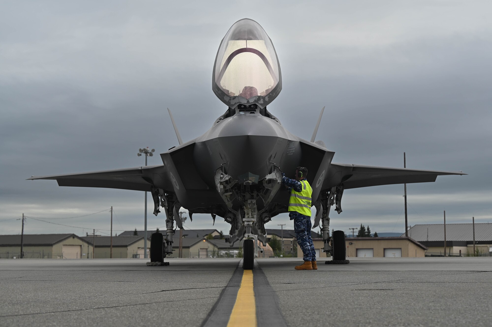 A Royal Australian Air Force maintainer, assigned to No. 75 Squadron, conducts pre-flight checks during Red Flag-Alaska 24-3 at Eielson Air Force Base, Alaska, Aug. 19, 2024.