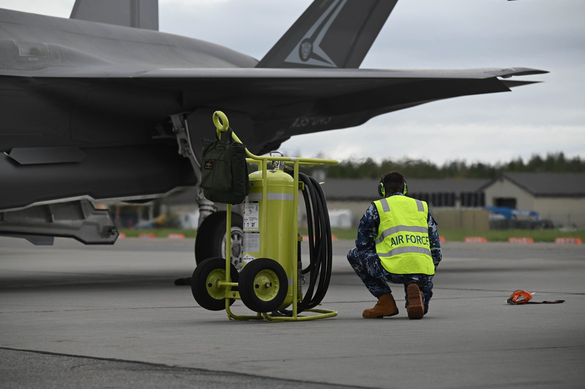A Royal Australian Air Force maintainer, assigned to No. 75 Squadron, conducts pre-flight checks during Red Flag-Alaska 24-3 at Eielson Air Force Base, Alaska, Aug. 19, 2024.