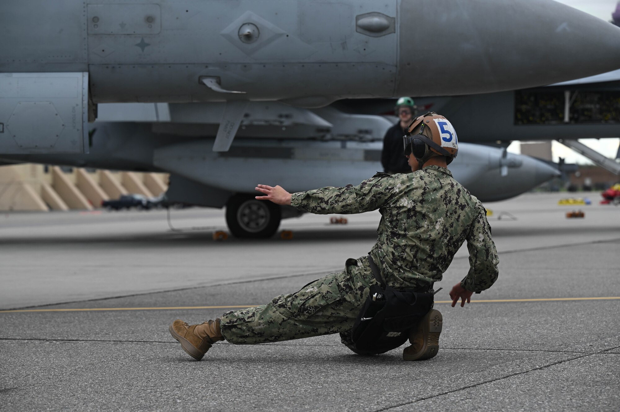 A U.S. Navy Aviation Machinist Mate, assigned to the Electronic Attack Squadron (VAQ-135), speaks on the radio during Red Flag-Alaska 24-3 at Eielson Air Force Base, Alaska, Aug. 19, 2024.