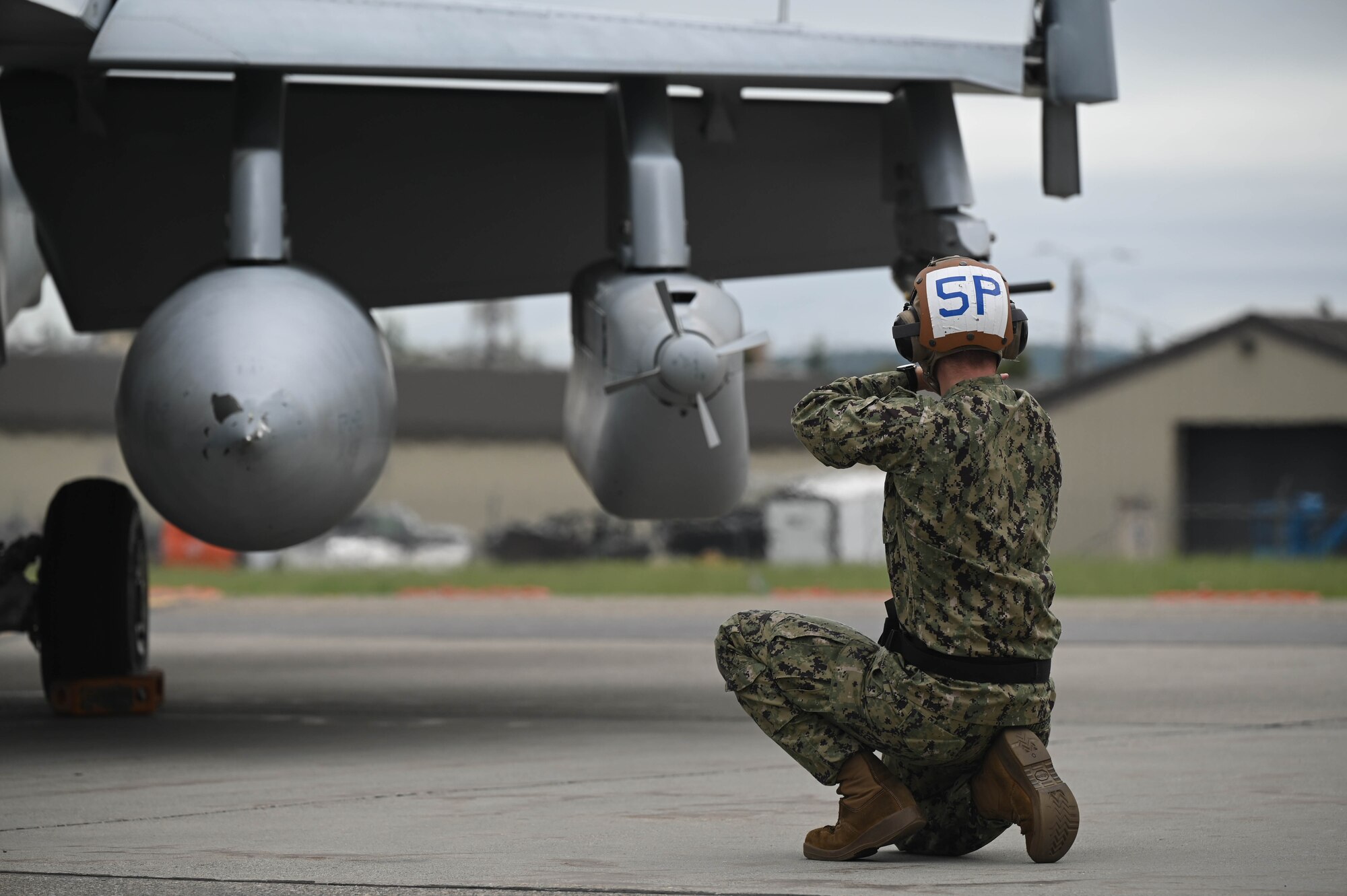 U.S. Navy Seaman Ayden Nuttbrock, Electronic Attack Squadron (VAQ-135) aviation machinist mate, guides an E/A-18G Growler through pre-flight checks during Red Flag-Alaska 24-3 at Eielson Air Force Base, Alaska, Aug. 19, 2024.