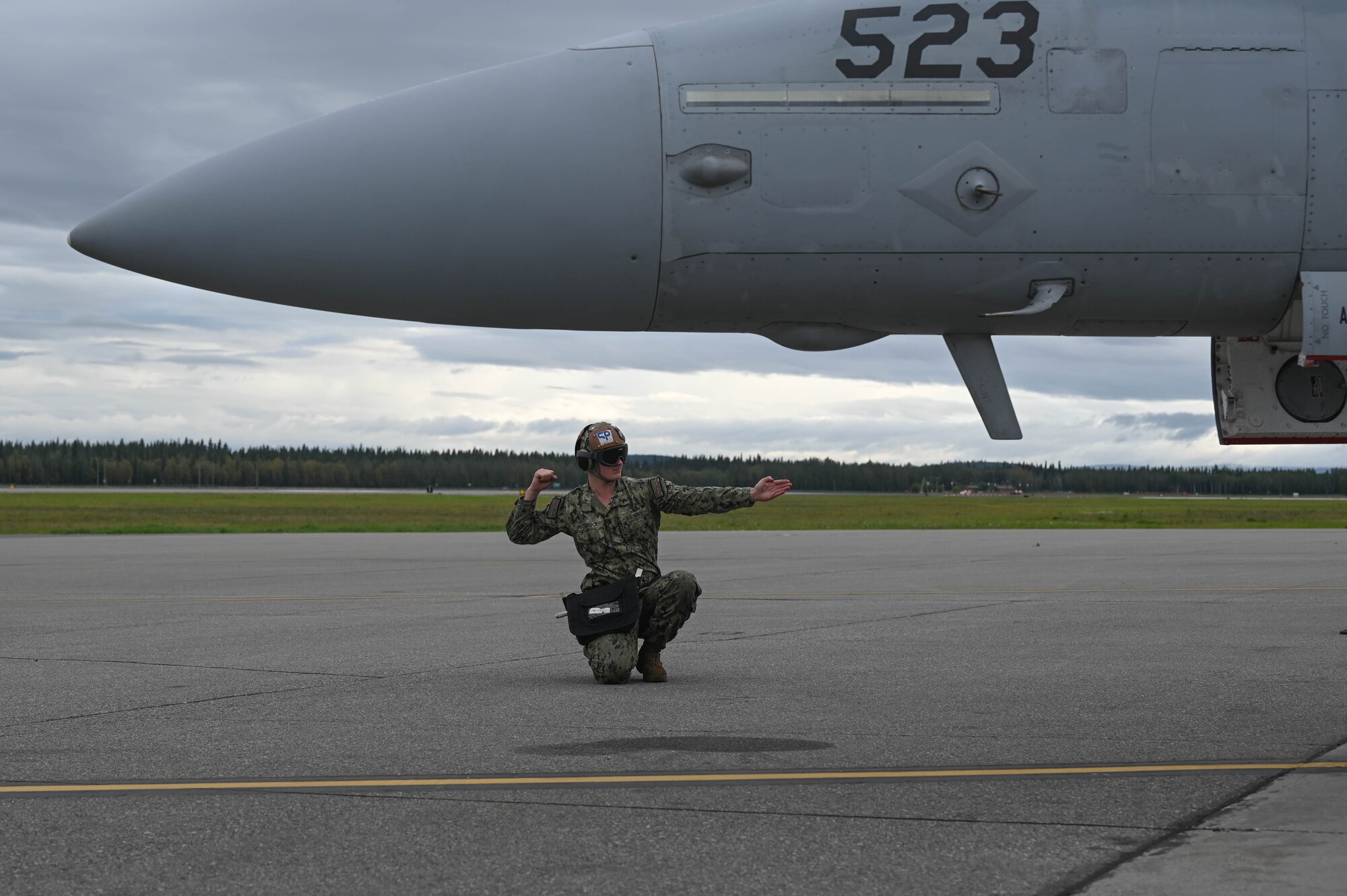 U.S. Navy Seaman Ayden Nuttbrock, Electronic Attack Squadron (VAQ-135) aviation machinist mate, guides an E/A-18G Growler through pre-flight checks during Red Flag-Alaska 24-3 at Eielson Air Force Base, Alaska, Aug. 19, 2024.
