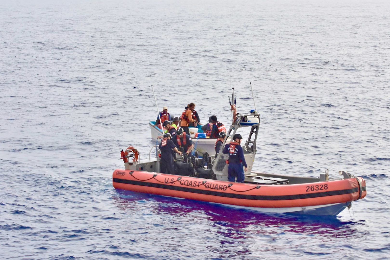 The crew of the USCGC Oliver Henry (WPC 1140) tow a disabled 22-foot fiberglass boat with six fishermen in good condition aboard about 11 nautical miles off Satawal,  Federated States of Micronesia, on Aug. 18, 2024. The vessel, which had been adrift after experiencing engine failure, was towed to Satawal Atoll by the Oliver Henry. The Joint Rescue Sub-Center (JRSC) Guam watch received a distress alert from a 406MHz Personal Locator Beacon (PLB) registered in the United States at approximately 9 a.m. local time on Aug. 17. The beacon, lent out by a Yap-based owner to outer island fishermen, was activated, signaling potential distress about 27 nautical miles north northeast of Satawal. (U.S. Coast Guard photo by Petty Officer 3rd Class Ryder Nollan)