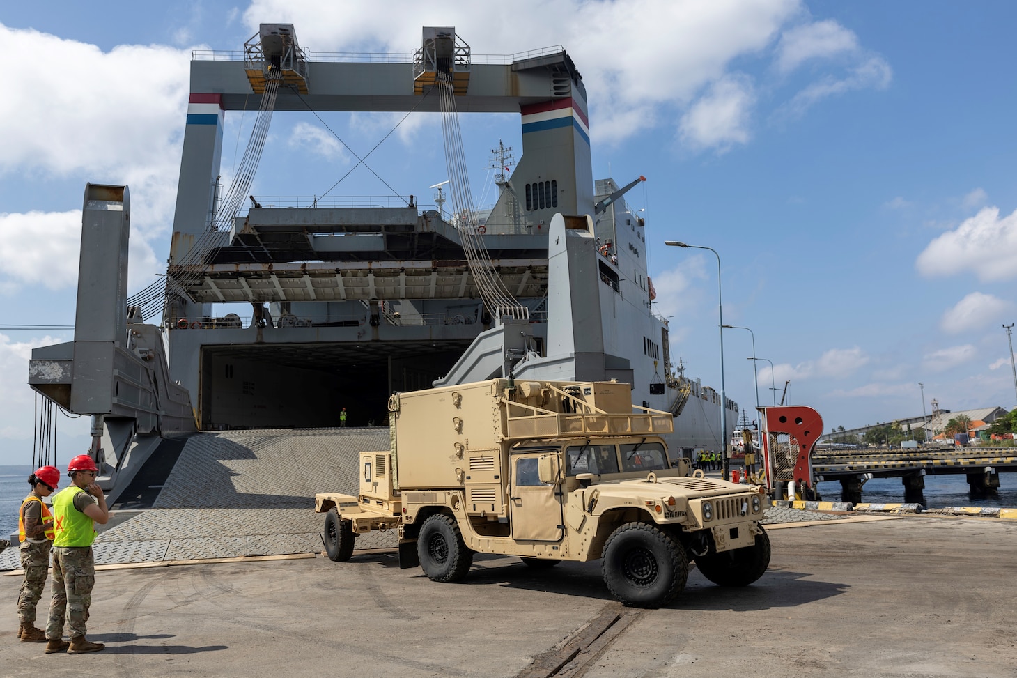 A military vehicle is driven out of Military Sealift Command chartered ship MV Cape Hudson (T-AKR 5066) during an offload of equipment in support of exercise Super Garuda Shield 2024, at the Port of Banyuwangi, Indonesia Aug. 12. Super Garuda Shield, one of the largest multinational exercises in the Indo-Pacific region, continues to solidify the U.S.-Indonesia Major Defense Partnership Defense Cooperation Agreement and advances cooperation in support of a free and open Indo-Pacific region. (Navy photo by Grady T. Fontana)