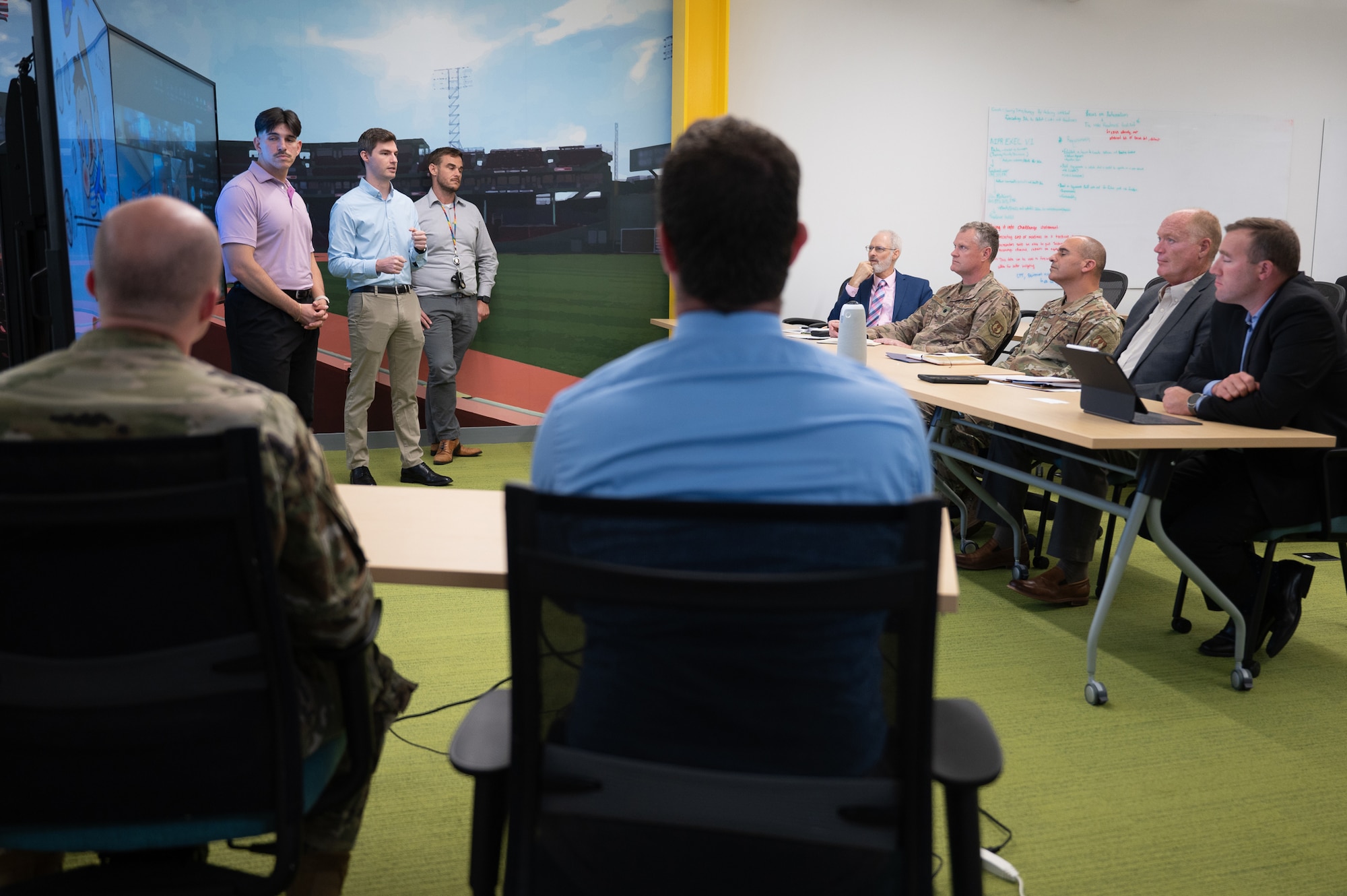 Image of three people making a presentation to group.