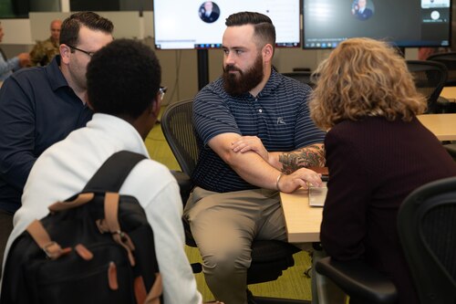 Image of four people talking.