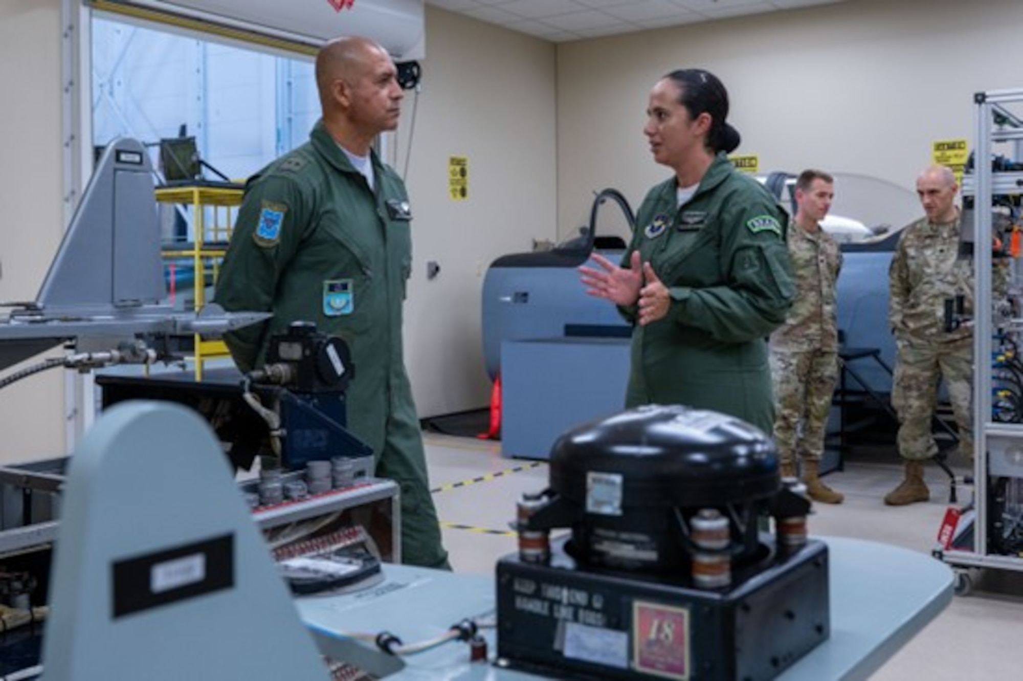 Primeiro Sargento Aline Marques, Brazilian Air Force, gestures as she speaks with Maj. Gen. Fábio Luis Morau, Brazilian Defense and Air Attache, during an immersion to the 318th Training Squadron at JBSA-Lackland, Texas, Aug. 6, 2024.