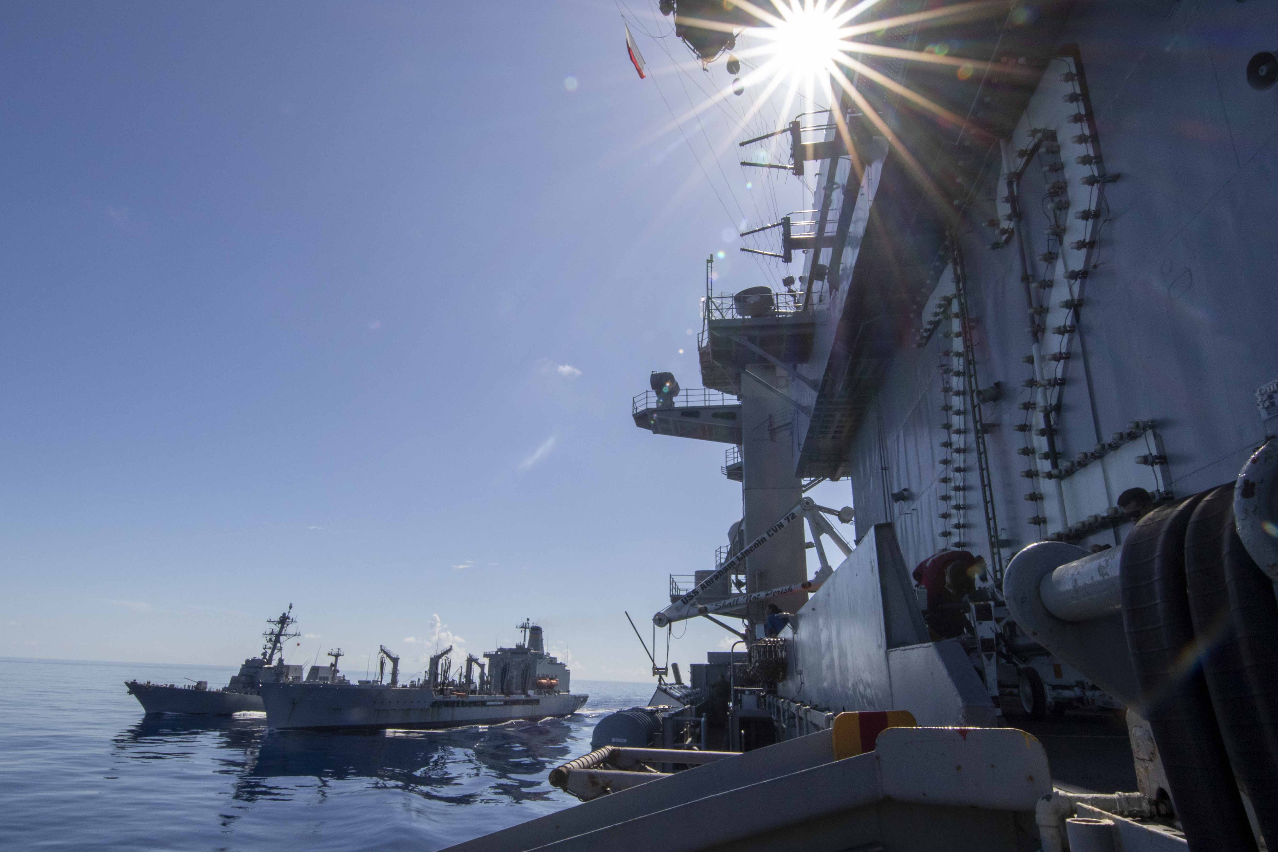 The Nimitz-class aircraft carrier USS Abraham Lincoln (CVN 72), breaks away from the Henry J. Kaiser-class USNS Rappahannock (T-AO 204), and the Arleigh Burke-class guided-missile destroyer USS Spruance (DDG 111) after a replenishment-at-sea (RAS). Abraham Lincoln, flagship of Carrier Strike Group Three, is underway conducting routine operations in the U.S. 7th Fleet area of operations.