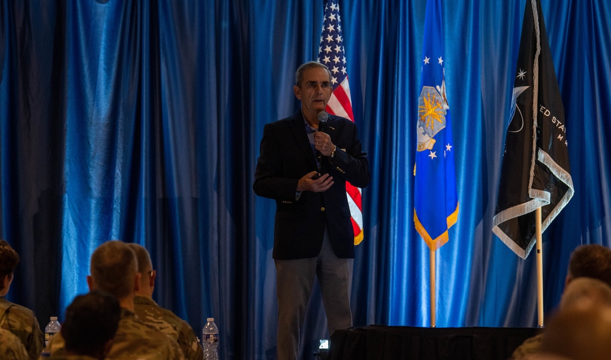 Retired Col. Lee Ellis, former F-4C Phantom fighter pilot and five-and-a-half-year Vietnam prisoner of war, delivers a keynote address at the U.S. Air Force Chaplain Corps annual summit in Arlington, Va., Aug. 7, 2024. During his address, Lee emphasized the significance of maintaining a positive attitude and connecting with others during challenging situations. (U.S. Air Force photo by Staff Sgt. Emmeline James)