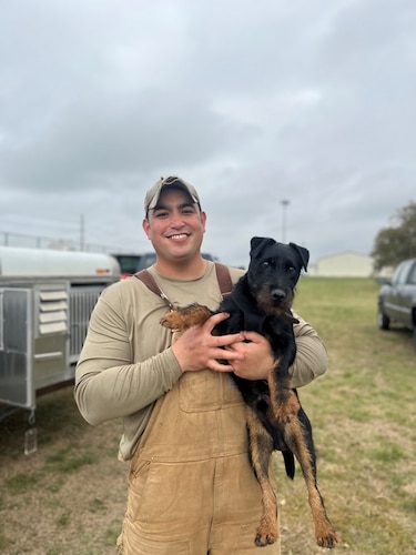 Tech. Sgt. Amadio Apilado, a Military Working Dog instructor, holds MWD Tery after training him in narcotics detection with the 341st Training Squadron at Joint Base San Antonio-Lackland, Texas, on March 6, 2023.
