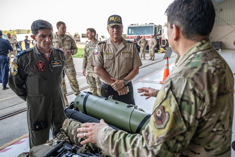 U.S. Air Force Master Sgt. Elmer Quijada, right, a pararescueman assigned to the 123rd Special Tactics Squadron, discusses the unit’s mission with Ecuadorian military and civilian emergency management officials during a tour of the Kentucky Air National Guard Base in Louisville, Ky., Aug. 6, 2024. The Ecuadorians were visiting as part of the State Partnership Program to learn more about the Kentucky Guard’s emergency response capabilities and interagency cooperation across the state. (U.S. Air National Guard photo by Dale Greer)