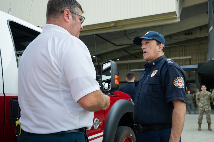 Severo Fernando Regalado Rosales, right, communications director for Cuenca Firefighters in Ecuador, talks to Dustin Behr, assistant fire chief at the 123rd Airlift Wing, during an information exchange for the State Partnership Program at the Kentucky Air National Guard Base in Louisville, Ky., Aug. 9, 2024. Rosales was one of six Ecuadorian military and civilian emergency management officials who spent a week touring Kentucky National Guard facilities and civilian emergency response agencies to learn more about the Kentucky Guard’s capabilities and interagency cooperation across the state. (U.S. Air National Guard photo by Dale Greer)