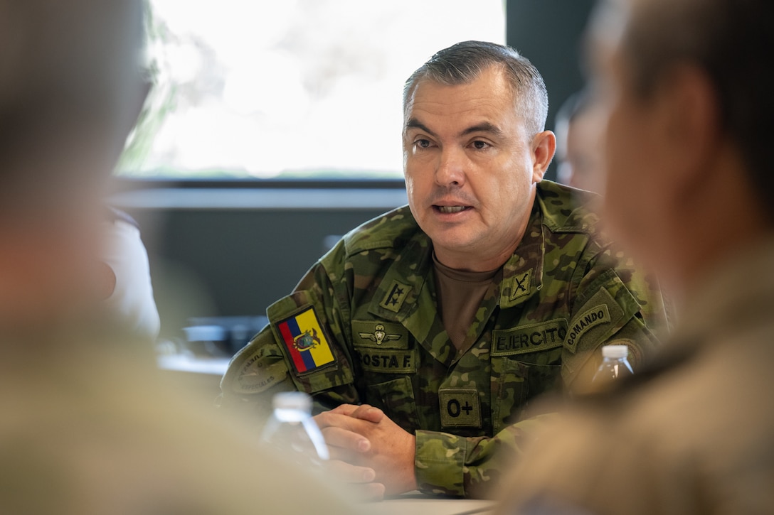 Ecuadorian Army Lt. Col. Wilson Francisco Acosta Duque, military zone coordinator for Ecuador’s emergency response system, talks to Airmen from the 123rd Airlift Wing during an information exchange for the State Partnership Program at the Kentucky Air National Guard Base in Louisville, Ky., Aug. 9, 2024. Duque was one of six Ecuadorian military and civilian emergency management officials who spent a week touring Kentucky National Guard facilities and civilian emergency response agencies to learn more about the Kentucky Guard’s capabilities and interagency cooperation across the state. (U.S. Air National Guard photo by Dale Greer)