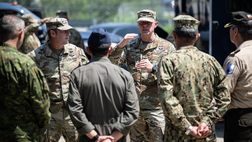 U.S. Army Capt. Patrick McCoy, operations officer for the Kentucky National Guard’s 41st Civil Support Team, discusses the unit’s disaster response capabilities with a group of Ecuadorian military and civilian emergency management officials during a tour of the Kentucky Air National Guard Base in Louisville, Ky., Aug. 6, 2024. The Ecuadorians were visiting as part of the State Partnership Program to learn more about the Kentucky Guard’s emergency response capabilities and interagency cooperation across the state. (U.S. Air National Guard photo by Dale Greer)