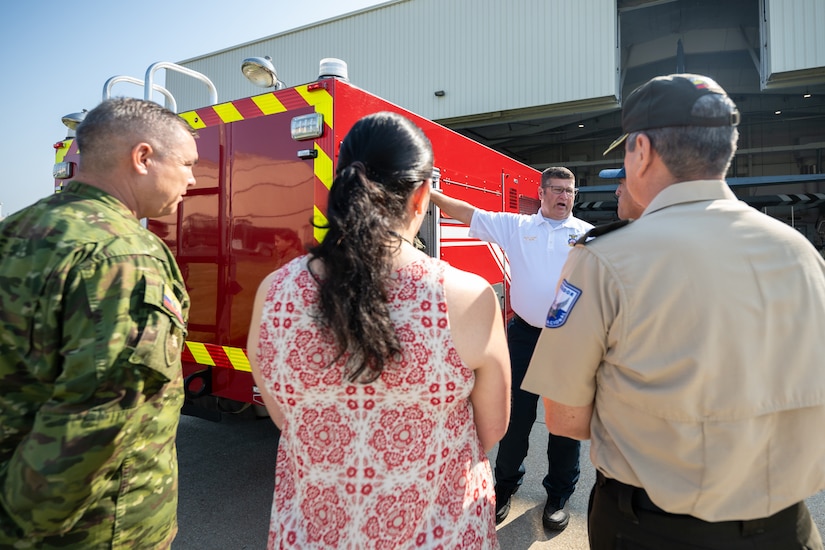 Dustin Behr, assistant fire chief at the 123rd Airlift Wing, discusses fire response capabilities with Ecuadorian military and civilian emergency management officials during a tour of the Kentucky Air National Guard Base in Louisville, Ky., Aug. 6, 2024. The Ecuadorians were visiting as part of the State Partnership Program to learn more about the Kentucky Guard’s emergency response capabilities and interagency cooperation across the state. (U.S. Air National Guard photo by Dale Greer)