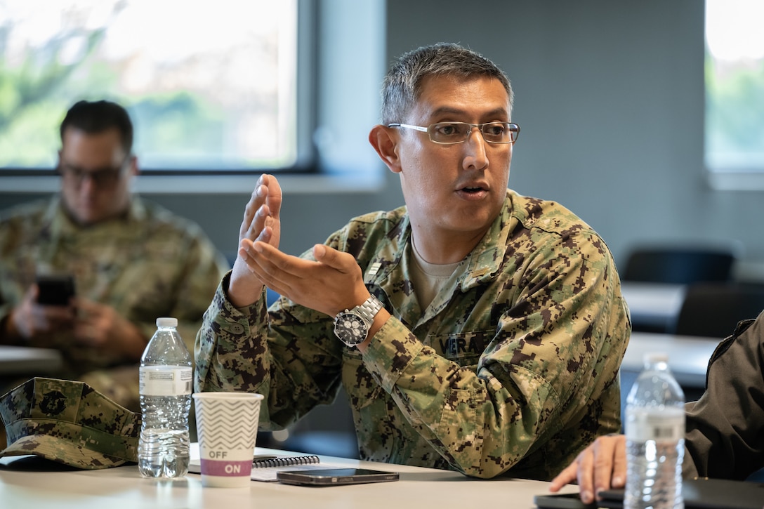 Ecuadorian Navy Lt. Cmdr. Victor Hugo Viera Salazar, head of education and doctrine for Navy general staff, talks to Airmen from the 123rd Airlift Wing during an information exchange for the State Partnership Program at the Kentucky Air National Guard Base in Louisville, Ky., Aug. 9, 2024. Salazar was one of six Ecuadorian military and civilian emergency management officials who spent a week touring Kentucky National Guard facilities and civilian emergency response agencies to learn more about the Kentucky Guard’s capabilities and interagency cooperation across the state. (U.S. Air National Guard photo by Dale Greer)