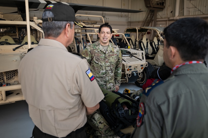 U.S. Air Force Master Sgt. Elmer Quijada, a pararescueman assigned to the 123rd Special Tactics Squadron, discusses the unit’s mission with Ecuadorian military and civilian emergency management officials during a tour of the Kentucky Air National Guard Base in Louisville, Ky., Aug. 6, 2024. The Ecuadorians were visiting as part of the State Partnership Program to learn more about the Kentucky Guard’s emergency response capabilities and interagency cooperation across the state. (U.S. Air National Guard photo by Dale Greer)