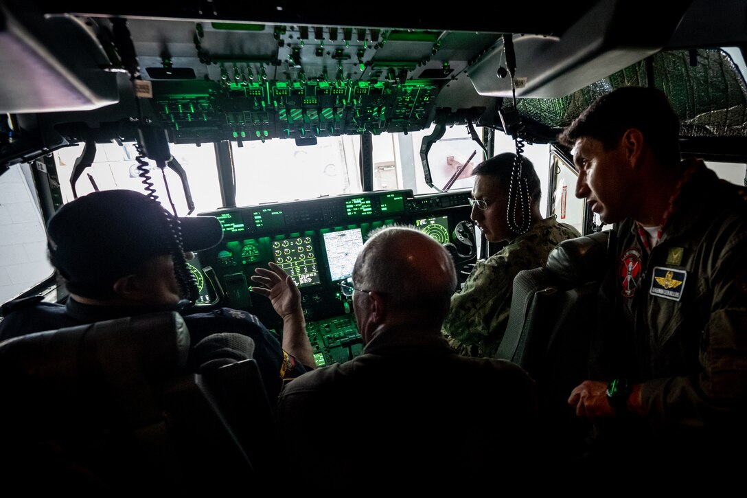 U.S. Air Force Lt. Col. Randall Hood, center, deputy commander of the 165th Airlift Squadron, discusses the airlift capabilities of the C-130J Super Hercules aircraft with Ecuadorian military and civilian emergency management officials during a tour of the Kentucky Air National Guard Base in Louisville, Ky., Aug. 6, 2024. The Ecuadorians were visiting as part of the State Partnership Program to learn more about the Kentucky Guard’s emergency response capabilities and interagency cooperation across the state. (U.S. Air National Guard photo by Dale Greer)