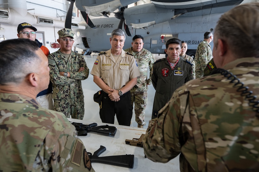 Members of the 123rd Security Forces Squadron discuss the use of non-lethal ammunition with Ecuadorian military and civilian emergency management officials during a tour of the Kentucky Air National Guard Base in Louisville, Ky., Aug. 6, 2024. The Ecuadorians were visiting as part of the State Partnership Program to learn more about the Kentucky Guard’s emergency response capabilities and interagency cooperation across the state. (U.S. Air National Guard photo by Dale Greer)