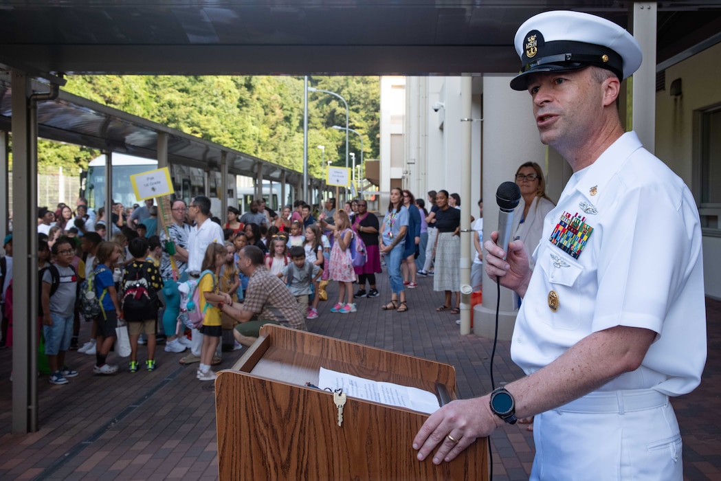 Command Master Chief Dennis Hunt, with Commander, Fleet Activities Yokosuka (CFAY), speaks to students of Ikego Elementary School onboard CFAY’s Ikego Heights Housing Area gathered for the first day of the 2024-2025 school year.