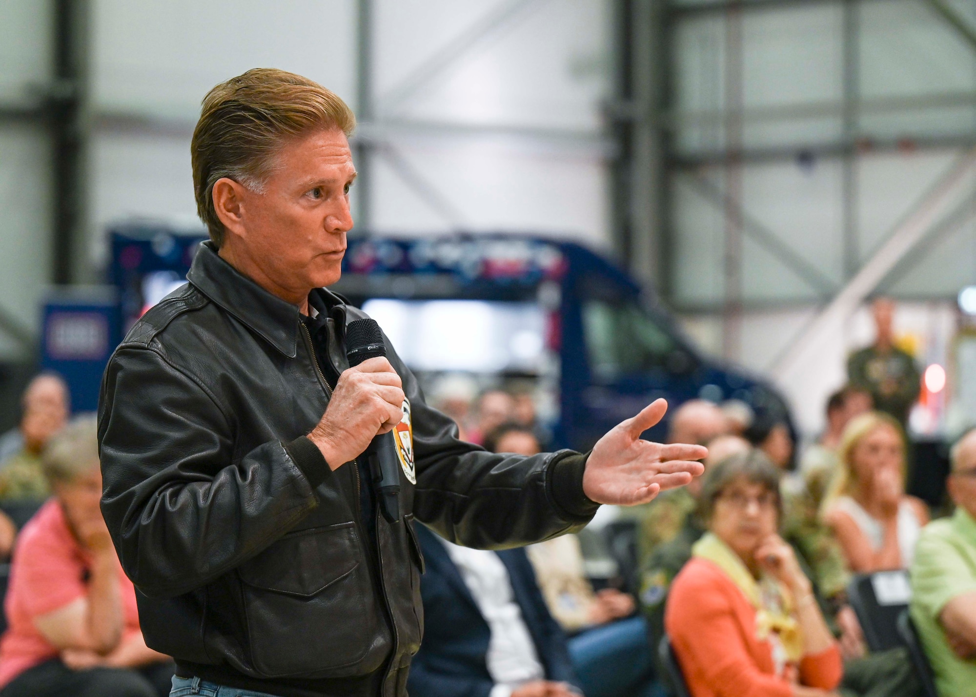 Curtis Wilson, 100th Bomb Group Foundation member, asks a question during a Q&A session for “Masters of the Air” during Heritage Day at Royal Air Force Mildenhall, England, Aug. 16, 2024. The Apple+ mini-series focused on the Eighth Air Force and the 100th Bomb Group during World War II and was highlighted as part of RAF Mildenhall’s Heritage Day celebration. (U.S. Air Force photo by Senior Airman Katie Mullikin)