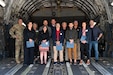 Col. Douglas Stouffer, 911th Airlift Wing commander, poses for a photo with the newest Steel City Honorary Commanders Association members aboard a C-17 Globemaster III, Aug. 13, 2024, at Pittsburgh International Airport.