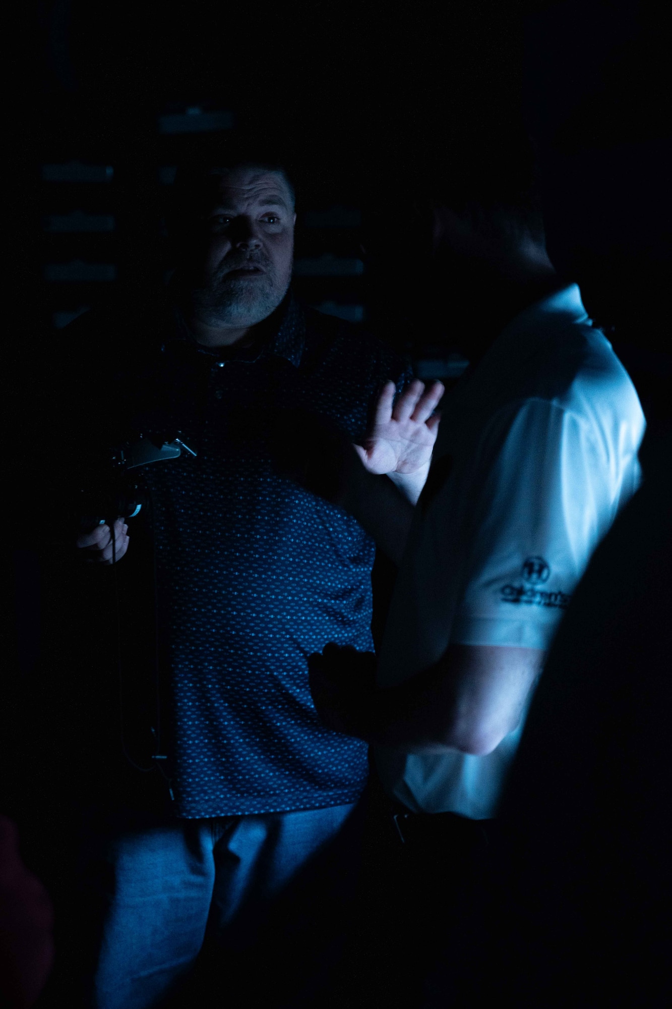 A civilian who works with the 437th Operations Support Squadron explains how Air Force pilots employ night vision goggles to Metro-Atlanta civic leaders.