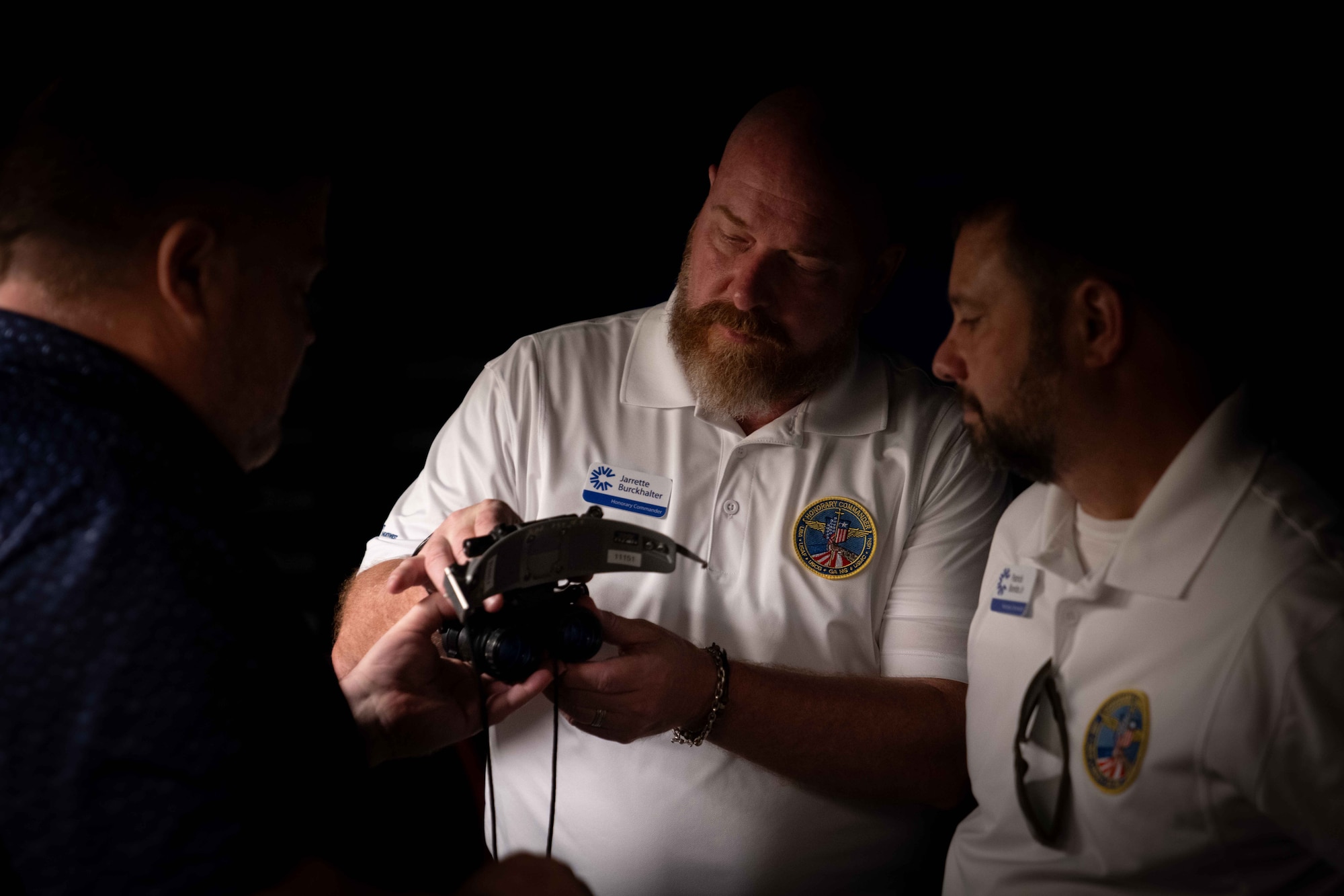 A 437th Operations Support Squadron civilian gives a night vision goggles presentation to civic leaders during a tour.