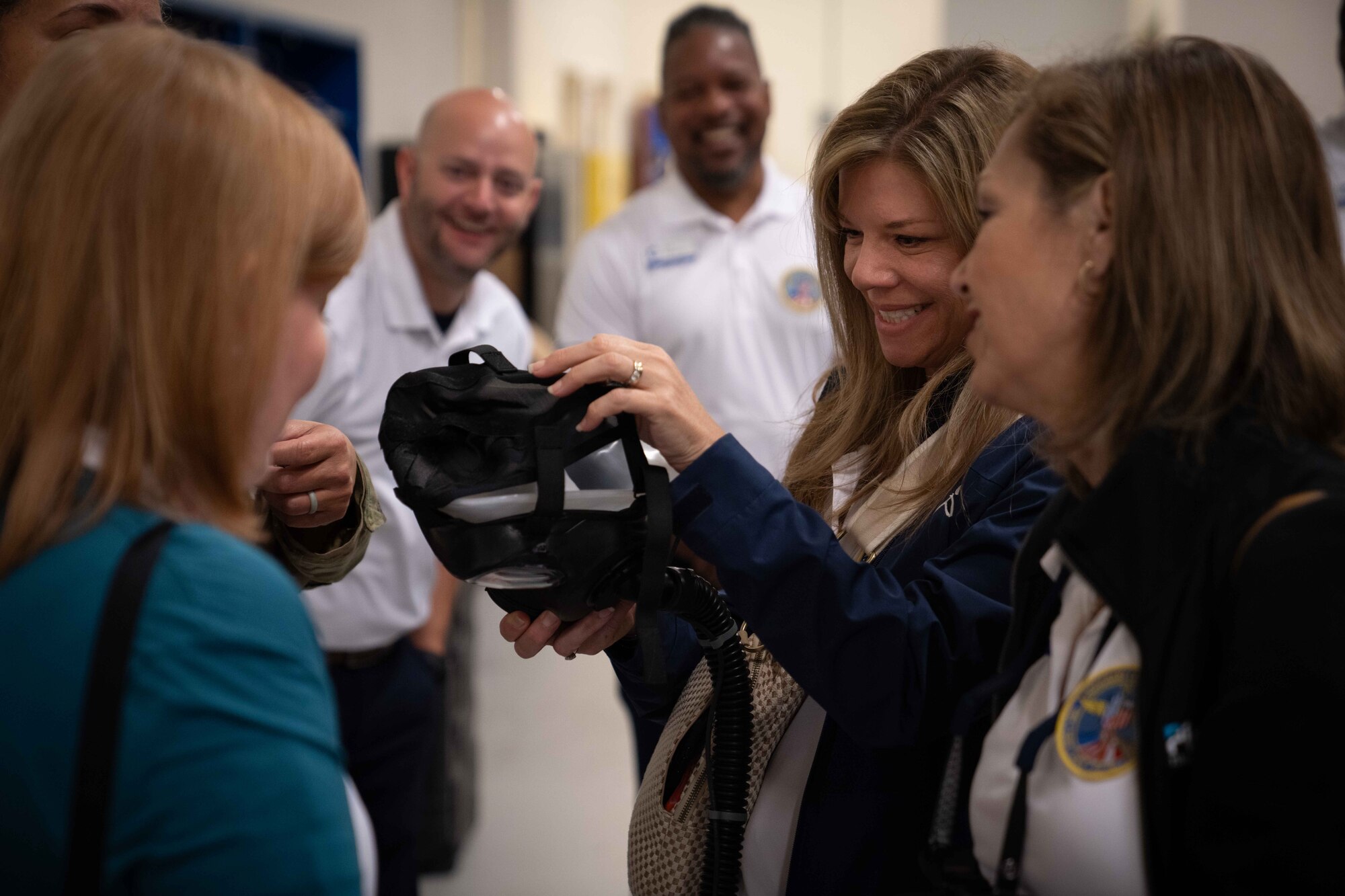 Civic leaders from the metro-Atlanta area examine an M-50 Gas Mask during a tour.