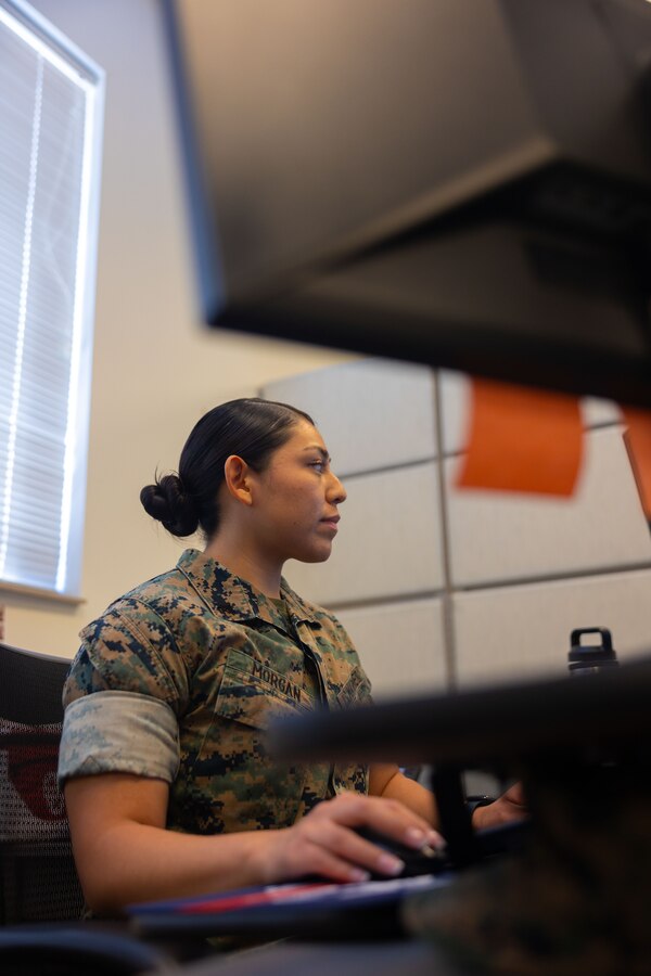 U.S. Marine Corps Cpl. Sharmayne Morgan, a personnel clerk with 4th Marine Corps District (4MCD), completes work at her desk at 4MCD headquarters in Columbus, Ohio, Aug. 14, 2024. As a personnel clerk, Morgan manages a variety of administrative tasks such as reviewing unit diaries, separations, orders, as well as checking in new Marines to the unit. (U.S. Marine Corps photo by Lance Cpl. Allegra Catalan-Dyson)