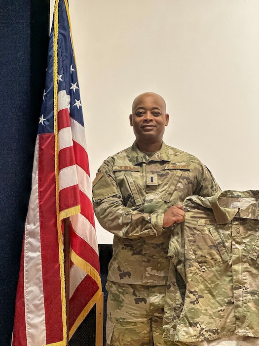 1st Lt. Frankie Jenkins Jr., 433rd Medical Squadron licensed clinical social worker, holds up his previously worn Master Sgt. Air Force uniform after he took the oath of office during an Air Force officer swearing in ceremony at the 433rd Airlift Wing on Jul. 29, 2024.