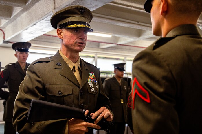 U.S. Marine Corps Lt. Col. Paul C. Trower, the battalion commander of 2nd Recruit Training Battalion, inspects a Marine’s rifle during a battalion commander’s inspection at Marine Corps Recruit Depot San Diego, July 31, 2024. The battalion commander surveys new Marines for knowledge, bearing, and attention to detail, and the inspection is one of the last tests before graduating. (U.S. Marine Corps photo by Lance Cpl. Eric Valerio)