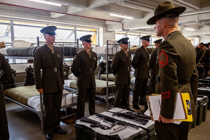 U.S. Marine Corps Pvt. Caden Thornton, a Marine with Hotel Company, 2nd Recruit Training Battalion, is inspected by Staff Sgt. Robert Stanton, a senior drill instructor with Fox Company, 2nd Recruit Training Battalion, during a battalion commander’s inspection at Marine Corps Recruit Depot San Diego, California, July 31, 2024.The battalion commander surveys new Marines for knowledge, bearing, and attention to detail, and the inspection is one of the last tests before graduating. (U.S. Marine Corps photo by Lance Cpl. Eric Valerio)