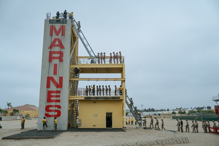 U.S. Marines with Golf Company, 2nd Recruit Training Battalion, climb up the rappel tower at Marine Corps Recruit Depot San Diego, California, Aug. 16, 2024. The rappel tower provides opportunities for the new Marines to gain confidence in themselves and their gear, and is one of the last training events Marines will conduct while aboard MCRD San Diego. (U.S. Marine Corps photo by Lance Cpl. Francisco Angel)