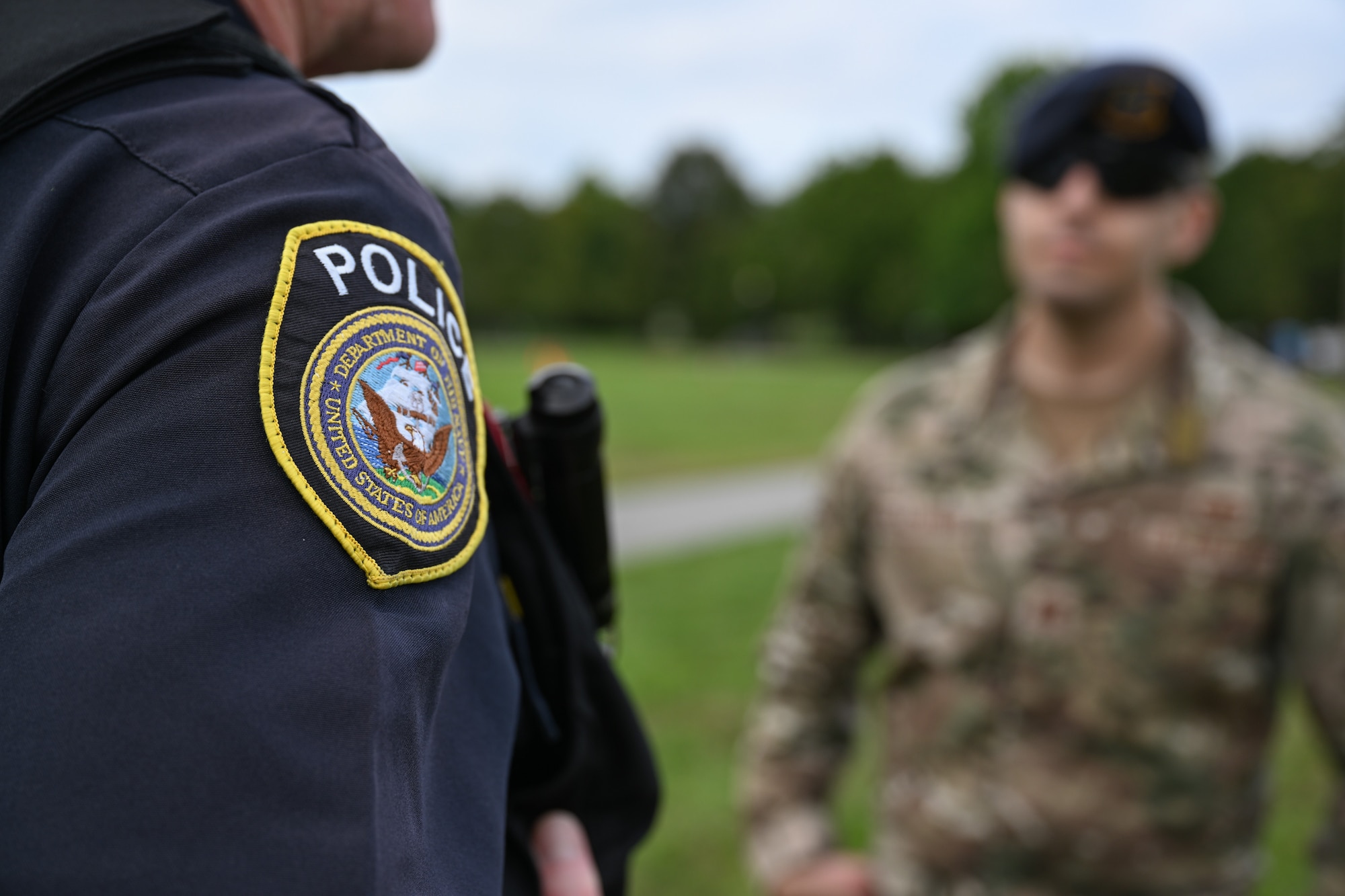 Image of civilian officer and security forces defender talking.