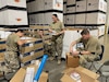 Soldiers with the 308th Medical Logistics Company, a reserve unit out of Utah, inventory equipment and supplies in military hospital sets during care of supplies in storage (COSIS) operation training at an Army Prepositioned Stocks site in Japan, known as APS-4J. Pictured, from left, are Spc. Michelle Romero, Spc. Brennon Wilder, Spc. Dasia Jones and Sgt. Preston Cook.