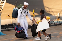 MU2 Brian Mathis reunites with his family after USS Blue Ridge (LCC 19) returns to Fleet Activities Yokosuka following a summer patrol.
