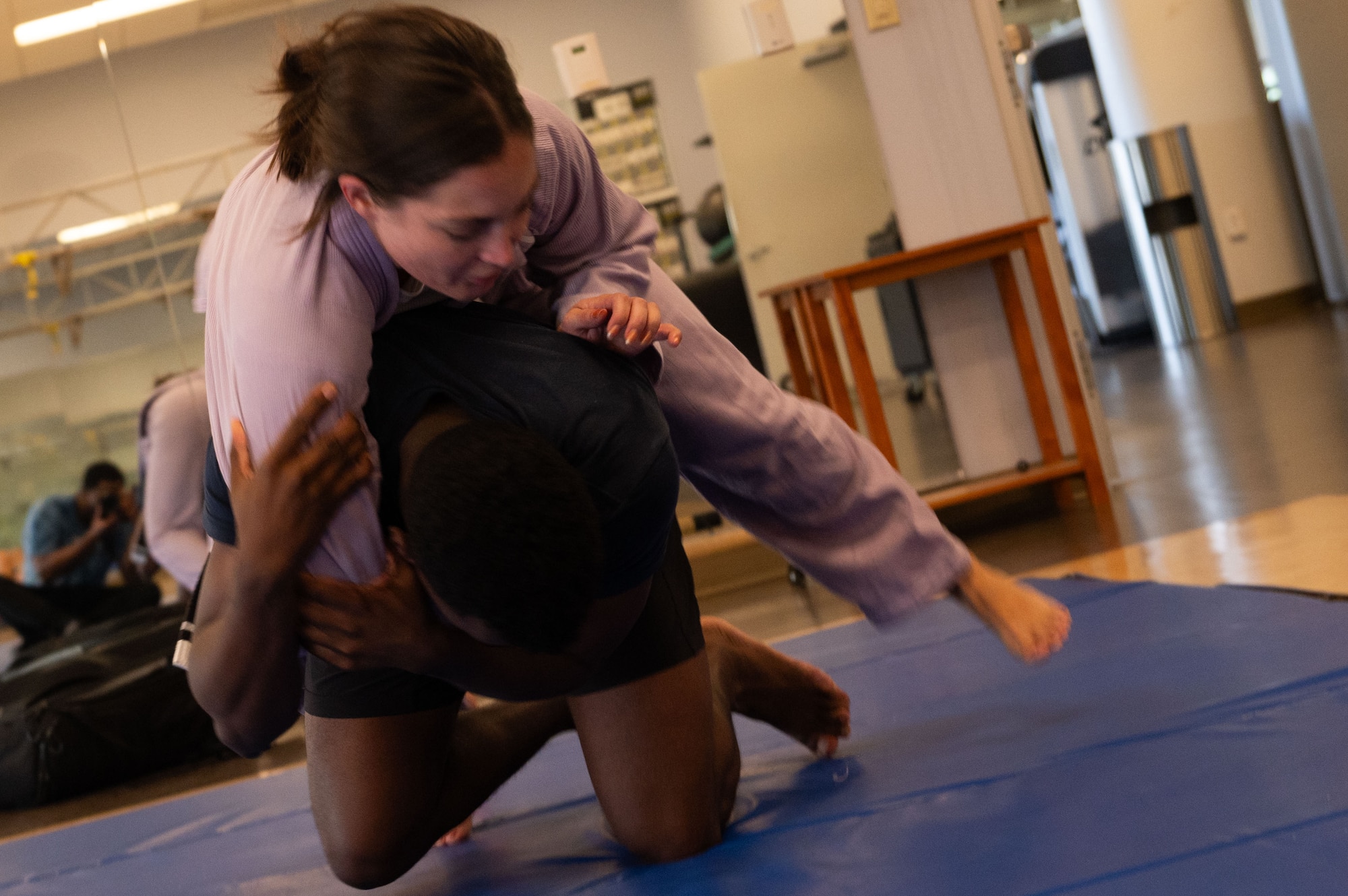 Senior Airman Timothy McCary, bottom, 436th Operational Medical Readiness Squadron bioenvironmental engineering technician, performs an arm spin during a Jujitsu class at Dover Air Force Base, Delaware, Aug. 15, 2024. Dover AFB's fitness center classes have played a role in Airmen maintaining mission-ready fitness. (U.S. Air Force photo by Senior Airman Dieondiere Jefferies)