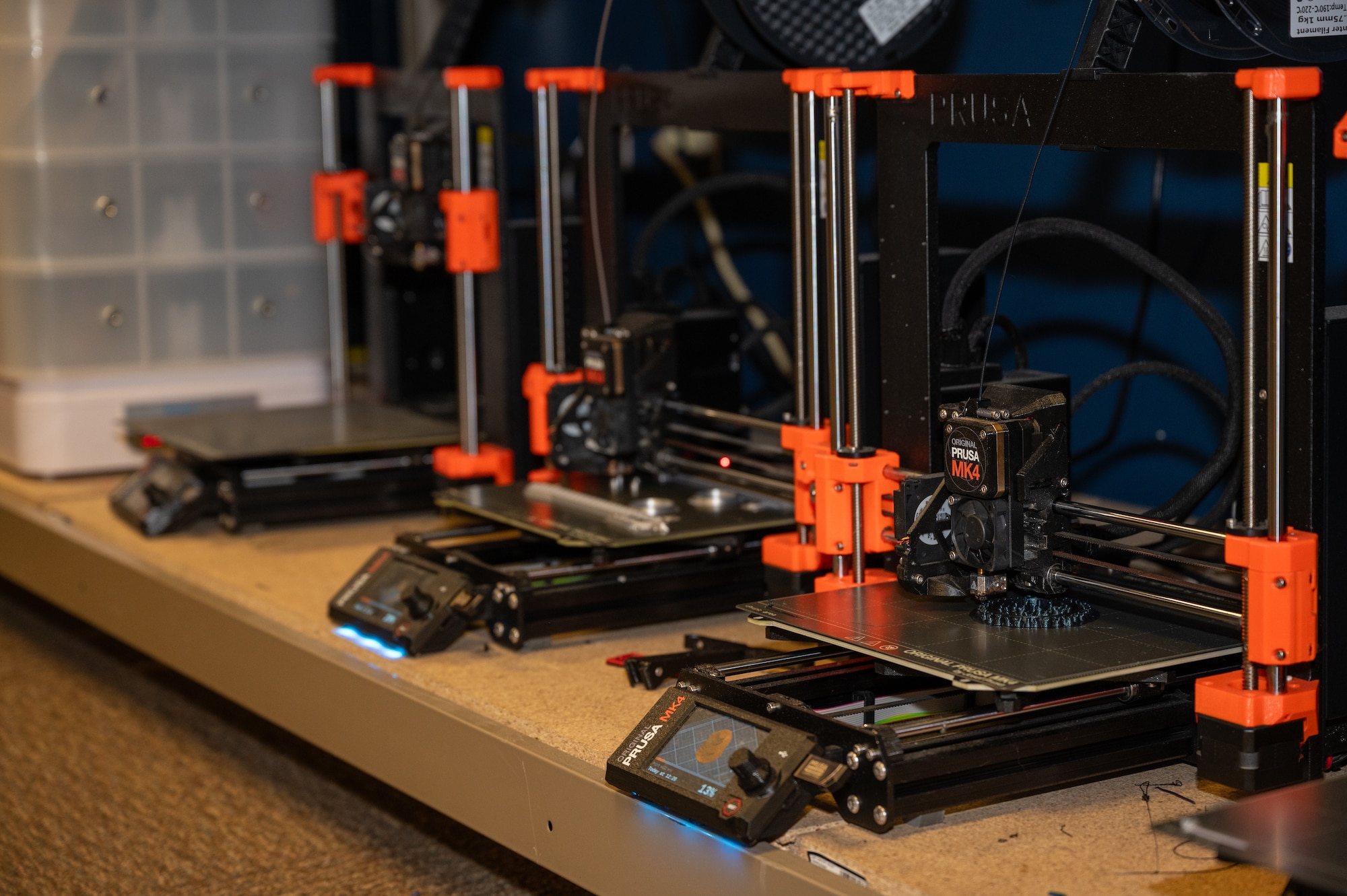 Tools being 3D printed for the 509th Maintenance Group Research and Engineering shop at Whiteman Air Force Base, Mo., July 29, 2024. The 509th MXG RE’s summer intern cohort is a program where selected interns from high school, college and Air Force ROTC are given the opportunity to work on projects, based on their fields of study. (U.S. Air Force photo by Airman 1st Class Bryce Moore)