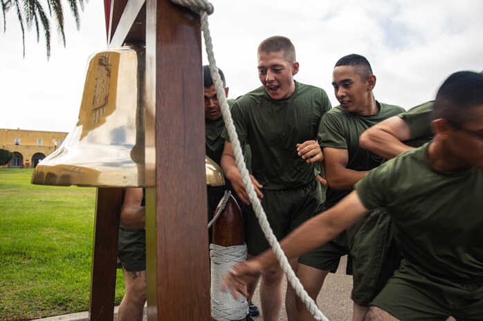 New U.S. Marines with Alpha Company, 1st Recruit Training Battalion, ring a liberty bell during a motivational run at Marine Corps Recruit Depot San Diego, California, Aug. 15, 2024. The company motivational run is a three-mile cadence run conducted around the Depot and is the last physical training event the Marines will conduct before they graduate from MCRD San Diego. The event is also the first-time friends and families will see their newly transformed Marines. (U.S Marine Corps Cpl. Sarah M. Grawcock)
