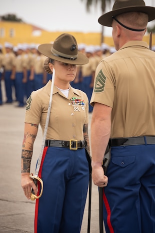 U.S. Marine Corps Gunnery Sgt. Phuong Tsan, chief drill instructor with Alpha Company, 1st Recruit Training Battalion, stands in formation during a graduation ceremony at Marine Corps Recruit Depot San Diego, California, Aug. 16, 2024. Graduation takes place at the end of the 13-week transformation process, which includes training for drill, marksmanship, basic combat skills, and Marine Corps customs and traditions. (U.S. Marine Corps photo by Lance Cpl. Janell B. Alvarez)