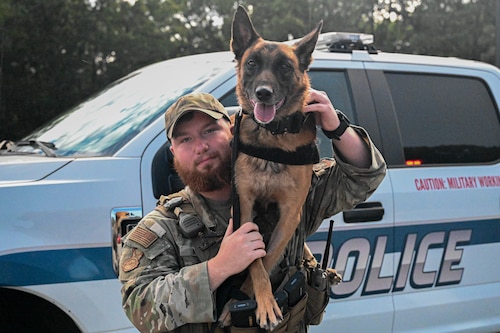 Senior Airman Clayton Aston, 19th Security Forces Squadron military working dog handler, poses with MWD, Mirco, at Little Rock Air Force Base, Arkansas, Aug. 16, 2024. While the MWD teams spend ample time training, they are also patrol ready and maintain security on the installation to ensure Team Little Rock members and the collective mission are not put at risk.
